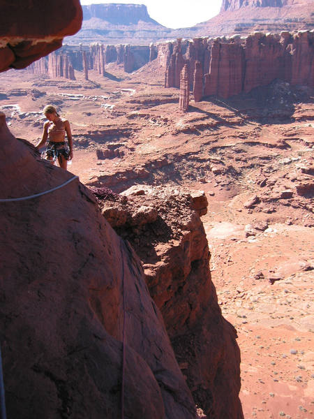 The late Erica Kutcher at the final belay on the Meemohive with Monument Valley in the background.  