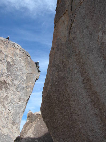 We had just climbed S/W Corner and I was setting up a rappel/top-rope for some friends on Cryptic.  This was a great climb.  Becareful rappelling down, as the natural direction of the rappel is right off the rock (open air).  My feet slipped off the rock on the way down and I took a 30 ft swing...  (This photo was taken by my friend Harry, not me).