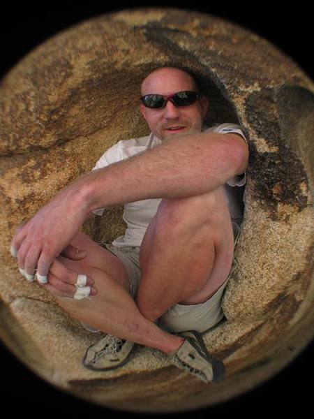 Woody's Womb on the Boulder adjacent to Pixie rock.  The problem is to crawl inside the scallop of the boulder facing out.  