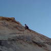 Timothy moving from the ledge to a bit of face climbing at the top instead of going for the easier crack 5' to his right.