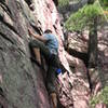 Rich searching for thin holds just above the block on Resurrection.