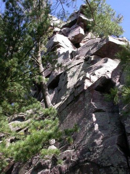 Jungle Gym passes to the left of the pine tree, then up the broken dihedral left of the roof.