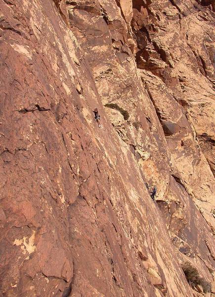 Bill Russell leads the face-climbing on pitch 2 while George Urioste belays.