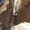 Looking down at the second belay position from near the start of pitch 3.  Plenty of chimney lies above...