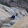 Christa checking out and approaching the chockstone on pitch 5.