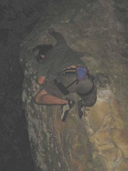 Brian starts the crux in the dark at the top of Donkey Dong. Photo copyright 2002 Melissa Moore.