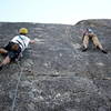 Brad testing his reach to see how much further he has to go to clip the second bolt!  Naoko Koike is in the middle of climbing Indian Springs.