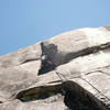 Paul placing gear at a difficult stance. The crux is a few feet above.