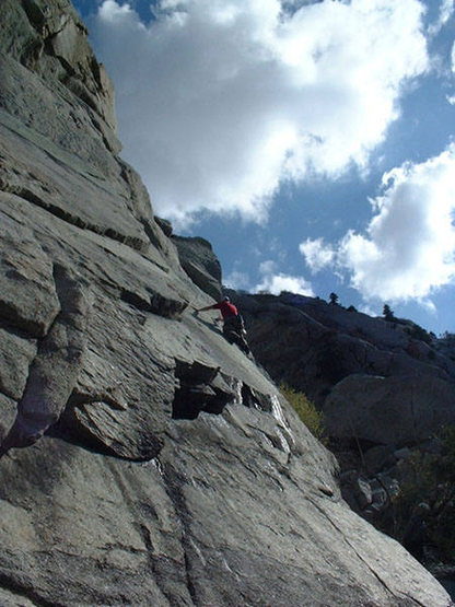 Mark climbing near the bolt on the slick slab, Smitty's Wet Dream.