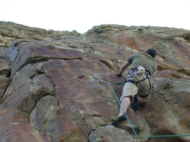 Cory trying to piece together the moves while hanging from the second bolt.